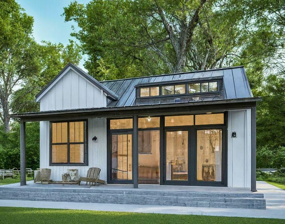 Can a Manufactured Home be an ADU - Modern white ADU with large windows and black trim.
